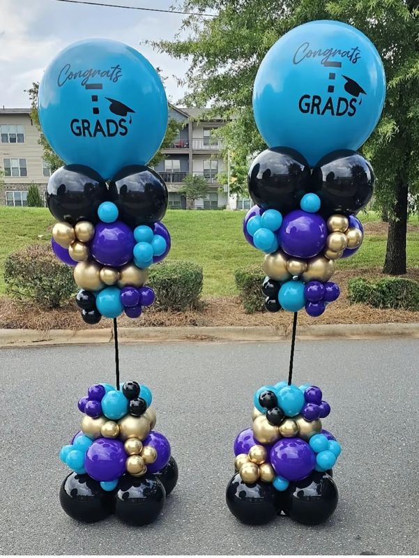 Two Congrats Grads balloon columns in purple, teal, gold and black
