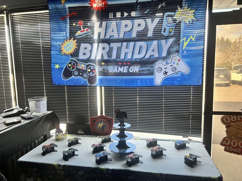 Video game themed Happy Birthday Game On backdrop with custom controller favors