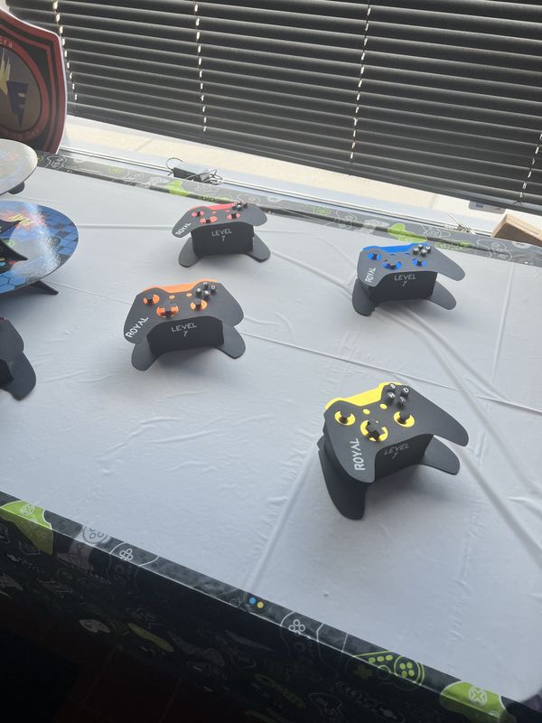 Handcrafted papercraft video game controllers branded ROYAL LEVEL 7